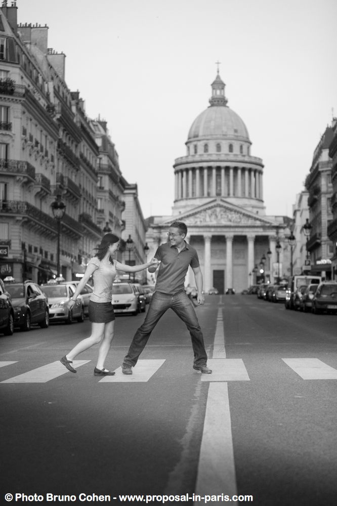 romantic shooting in paris proposal couple crossing road black and white