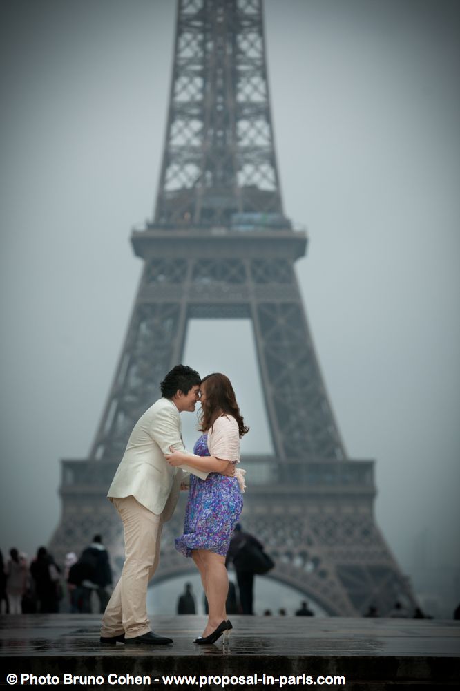 asian couple forehead against forehead from Trocadero front of Eiffel Tower  at sunrise in love