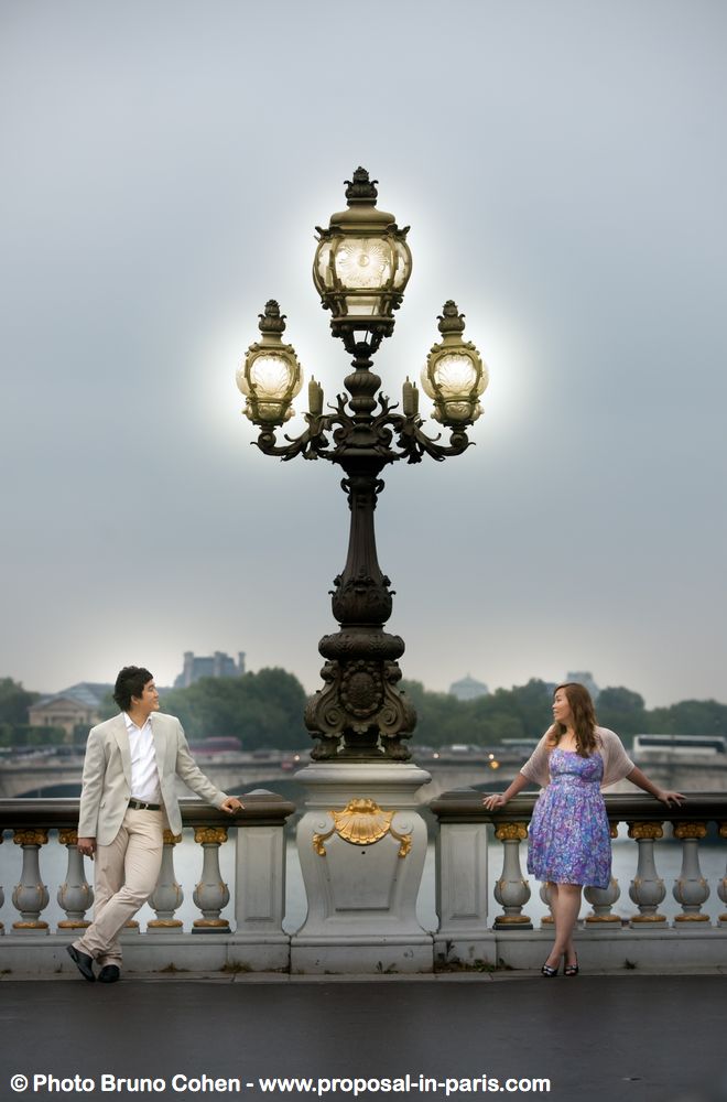 fashion portrait asian couple romantic bridge in paris proposal near Eiffel Tower love smile 