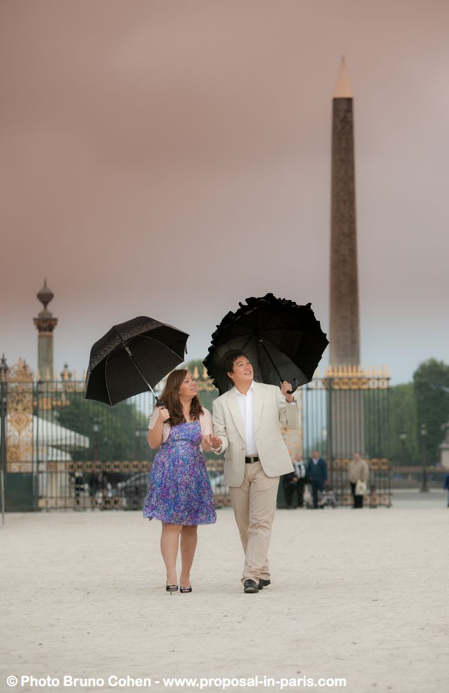 portrait asian couple walking with umbrella look far away love proposal in paris