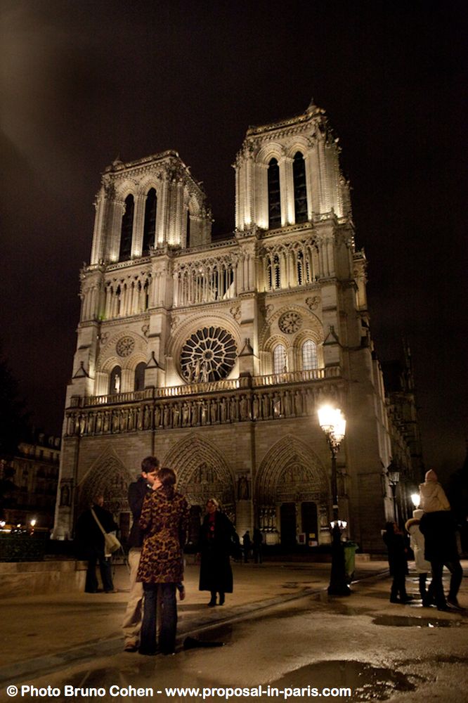 proposal in paris notre dame cathedral at night