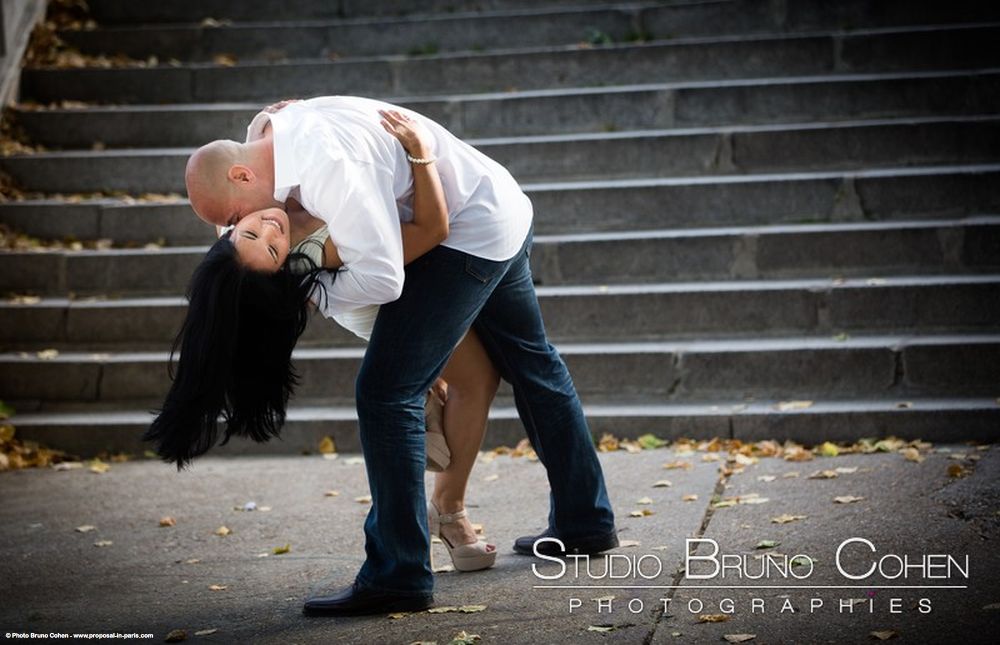engagement session in paris couple dancing love from quai de seine near Eiffel Tower 