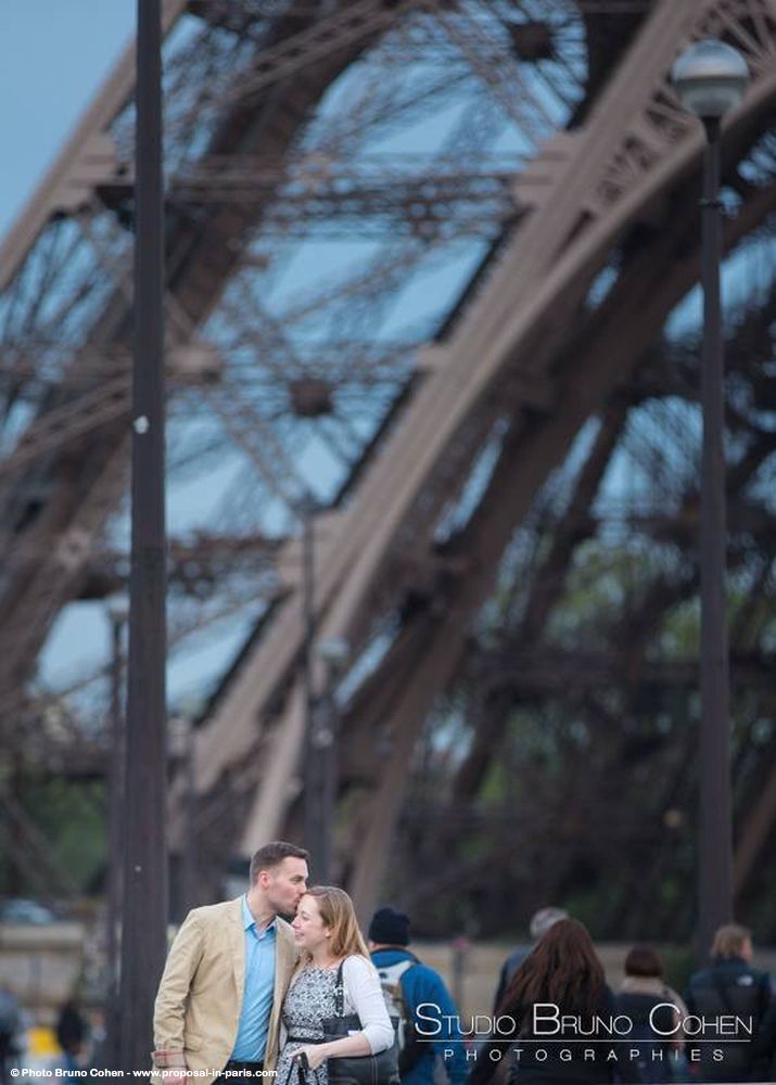 portrait couple in love hugs front of Eiffel Tower at sunset