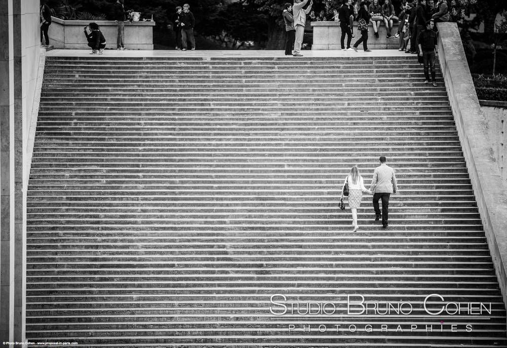 fashion portrait couple going upstairs in Trocadero black and white proposal in paris 