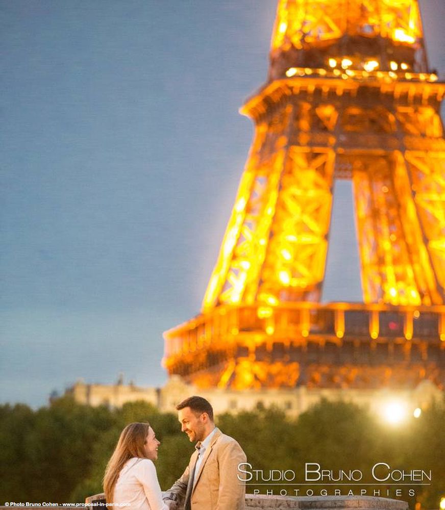 portrait couple in love face to face front of Eiffel Tower from paris at night 