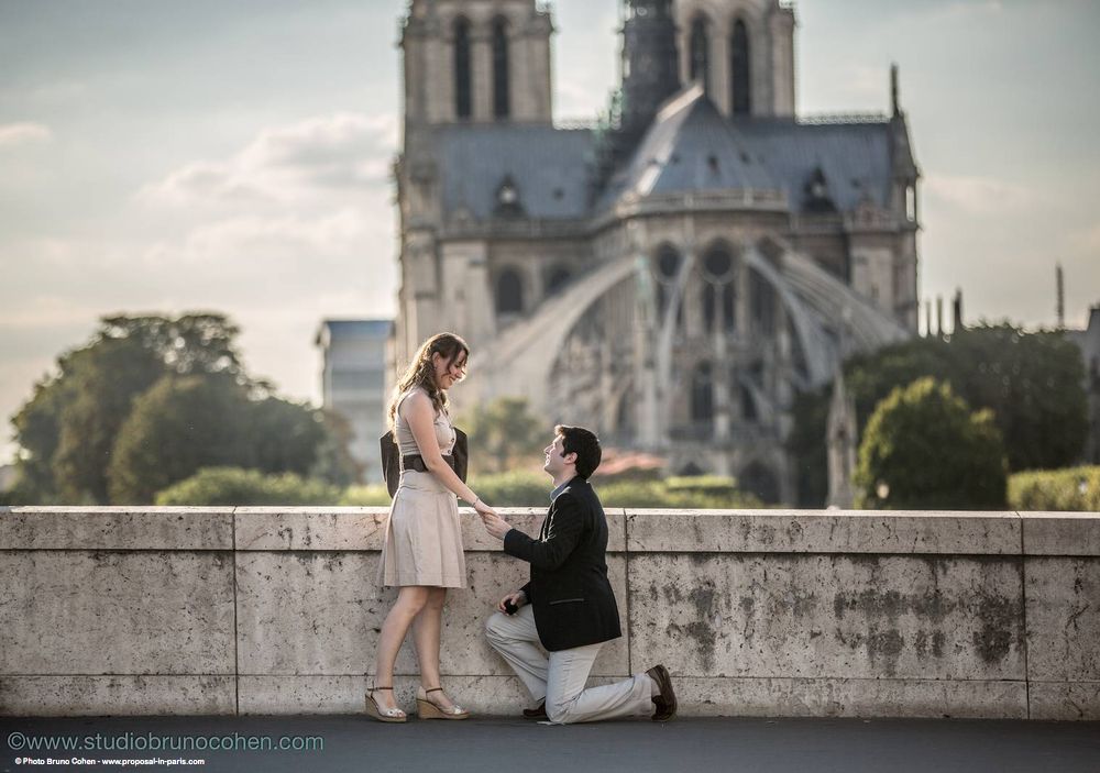 surprise proposal in paris engagement couple love from paris front of notre dame cathedral 
