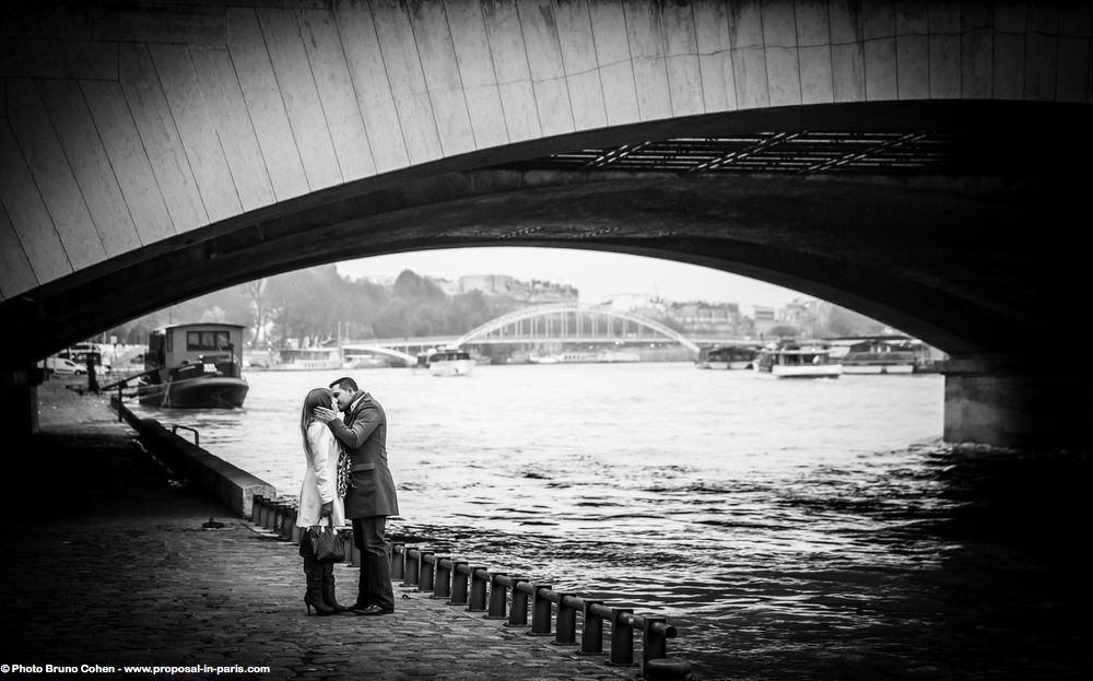 portrait kissing couple from quai de seine near Eiffel Tower in paris engagement session love happy emotions