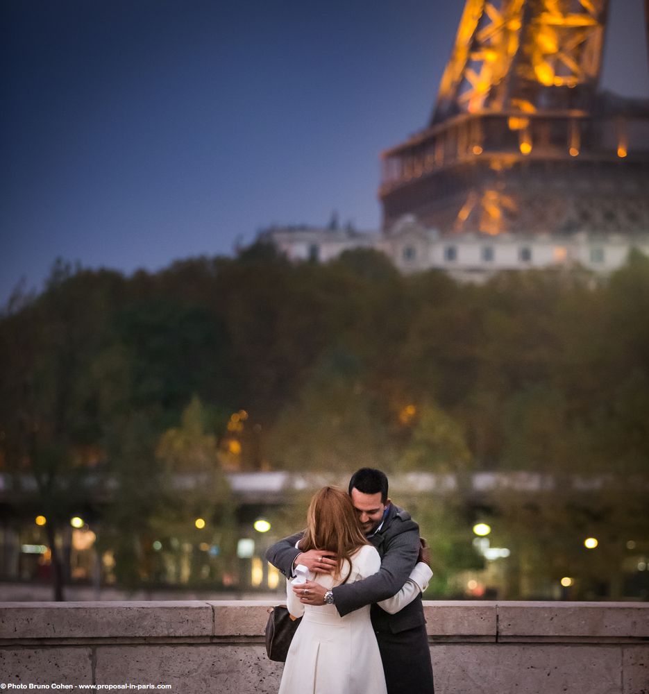 portrait hugging couple front of Eiffel Tower proposal in paris at night love emotions surprise