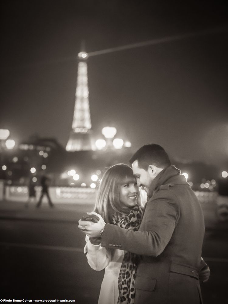 portrait couple in love forehead against forehead front of Eiffel Tower in paris black an white at night  