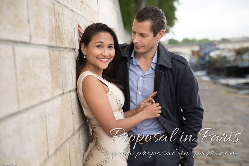 portrait couple in love standing in quai de seine near Eiffel Tower