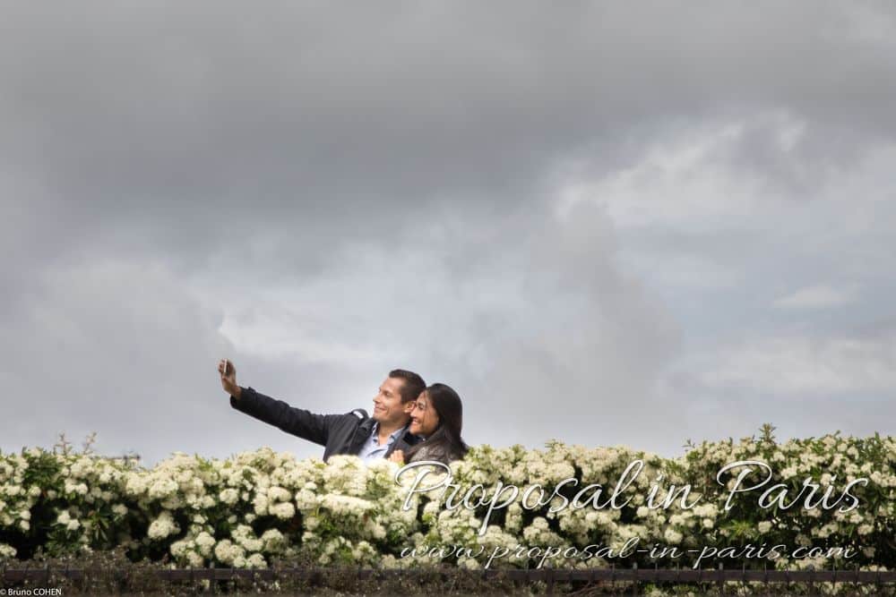couple in love taking selfie in paris proposal
