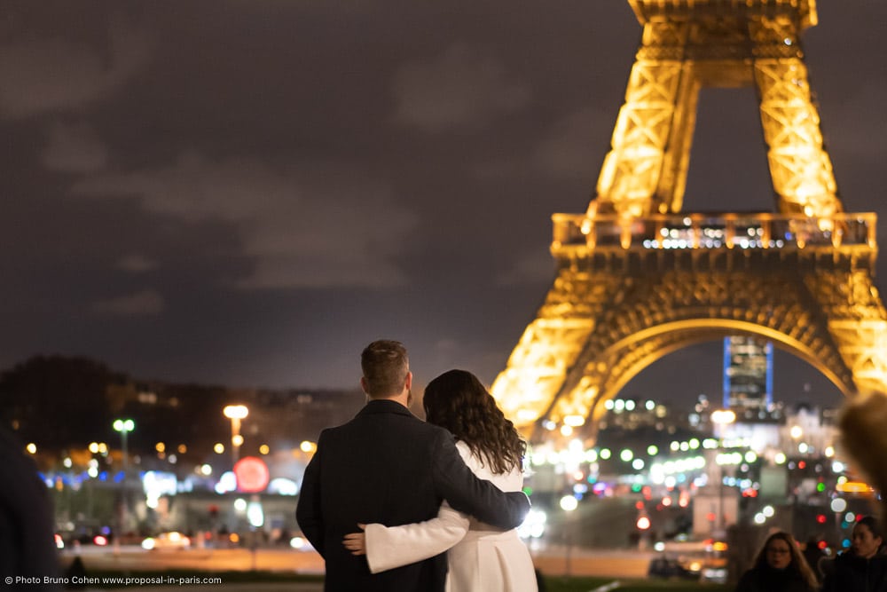 couple in love in front of Eiffel Tower by night