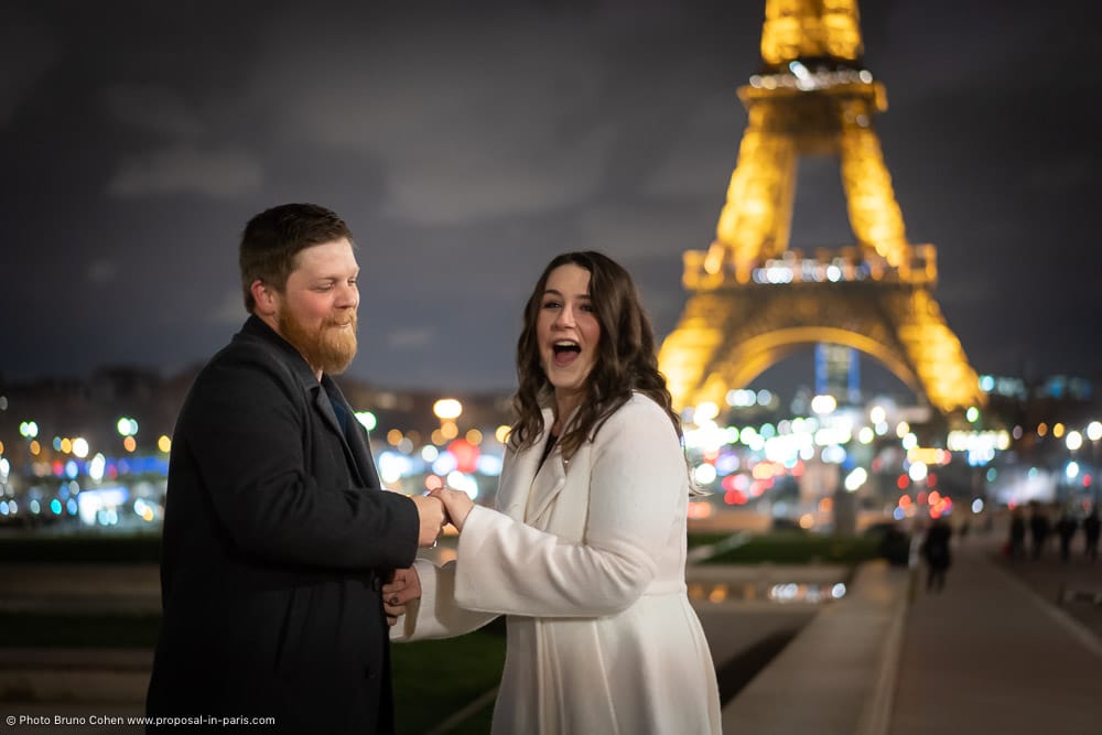 surprise lady after proposal in front Eiffel Tower at night