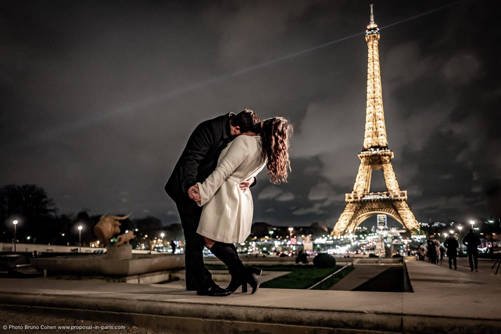 couple in love dancing from the Trocadero front of Eiffel Tower at night