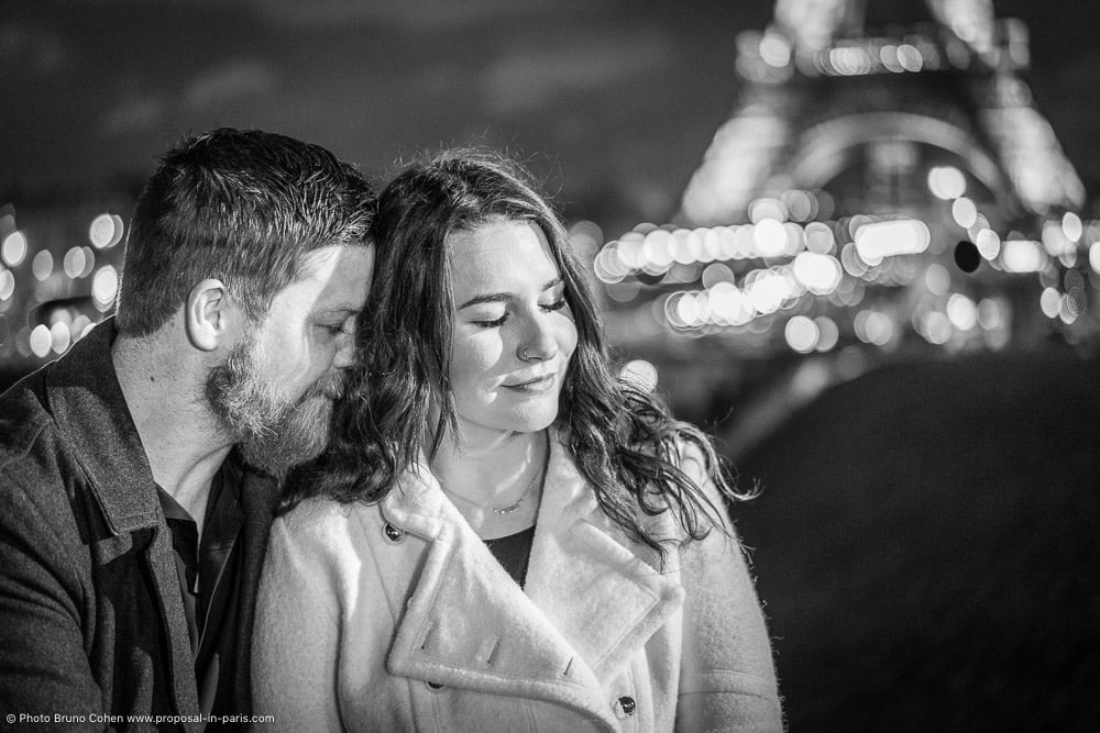 couple in love front of Eiffel Tower in black and white