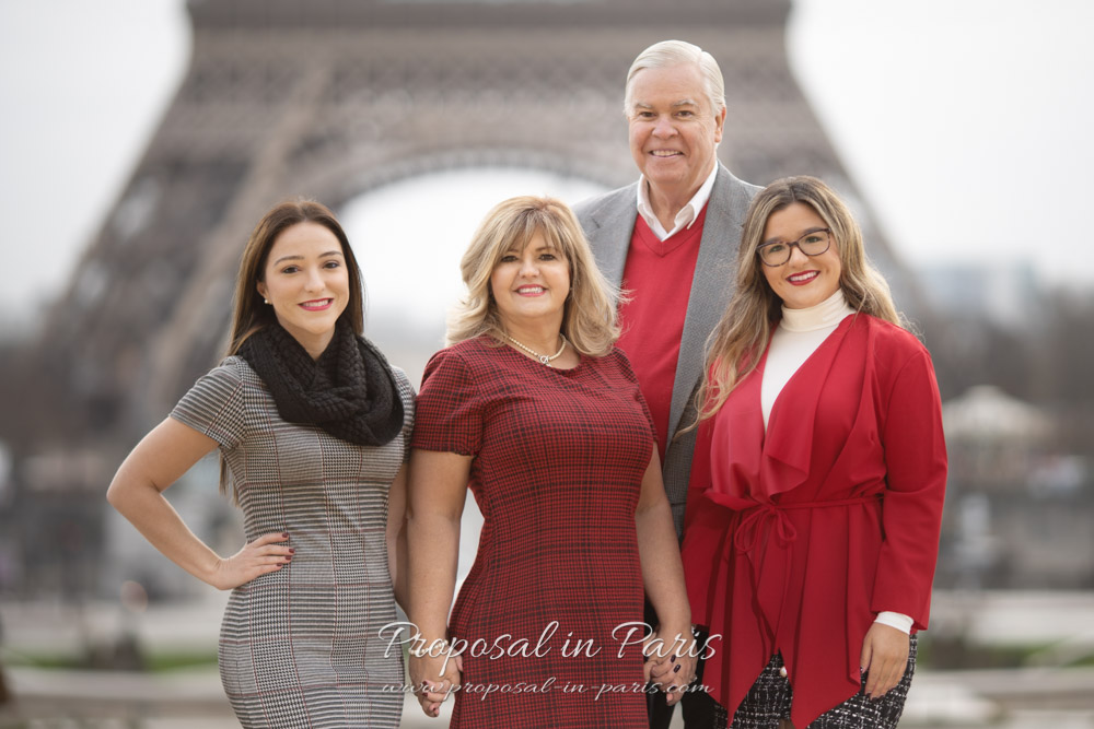 classic family portrait group shot in front of the Eiffel tower Paris