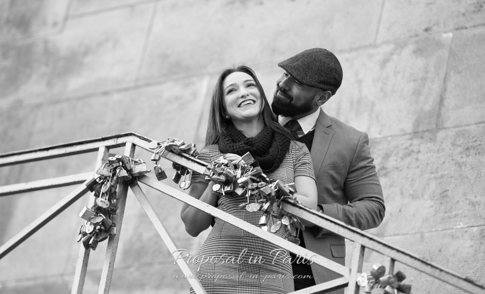 young smiling couple on stairs with love locks in black and white