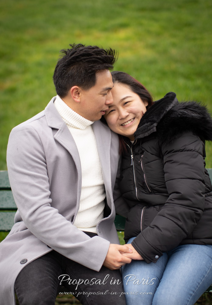 couple in love on a bench with green grass backdrop