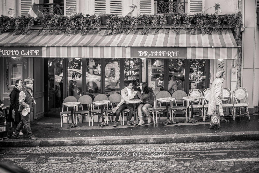 Couple seated in a cafe terrasse black and white with sepia tones