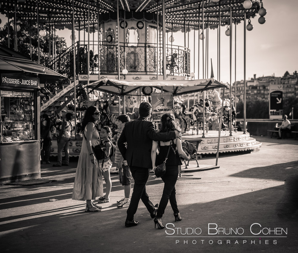 proposal in paris hidden photographer couple walk front of eiffel tower carousel black an white