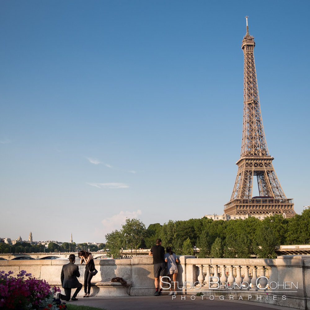 surprise proposal in paris couple in love emotions cry on bir hakeim bridge front of eiffel tower at sunset