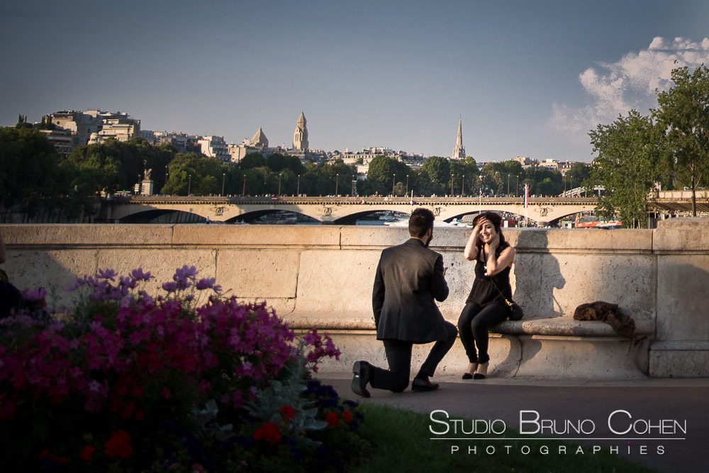 surprise proposal in paris couple in love emotions cry on bir hakeim bridge front of eiffel tower at sunset