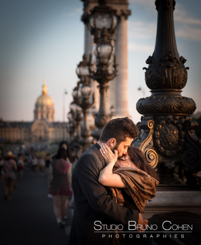 portrait kissing couple in paris from alexander III bridge at sunset proposal summer 