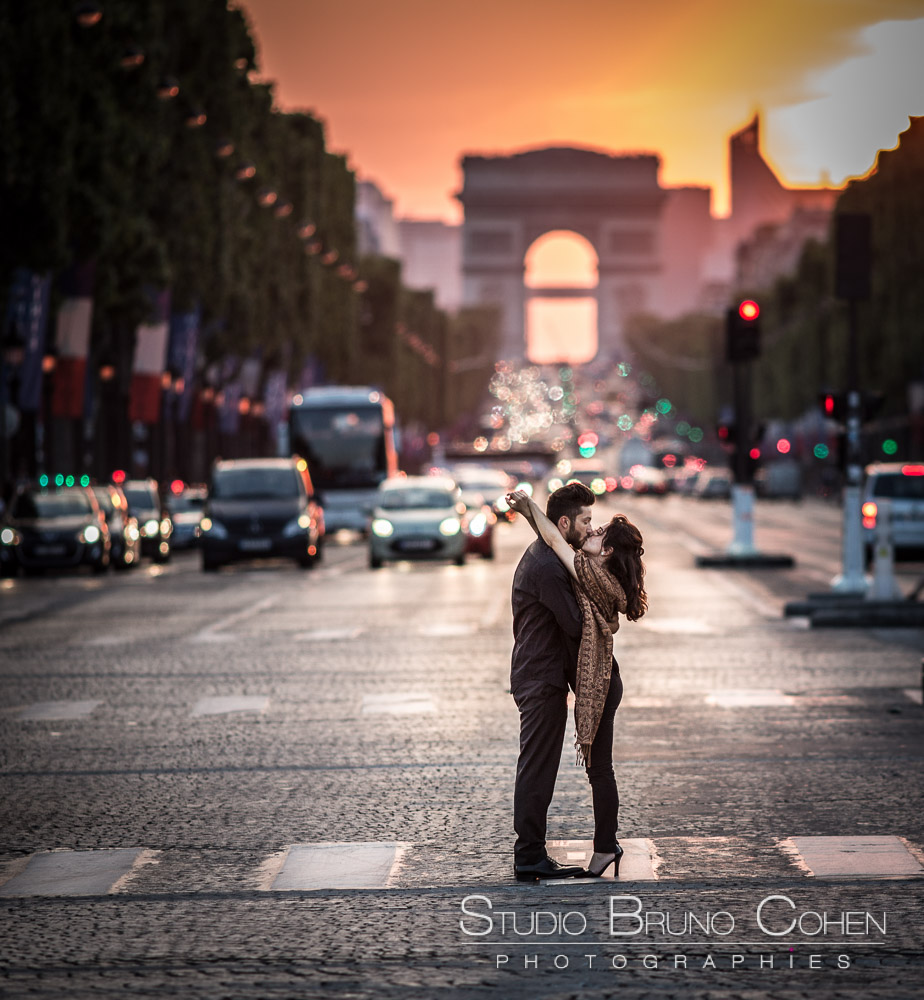 portrait couple in love face to face in paris from  Champs Elysee arc de triomphe sunset