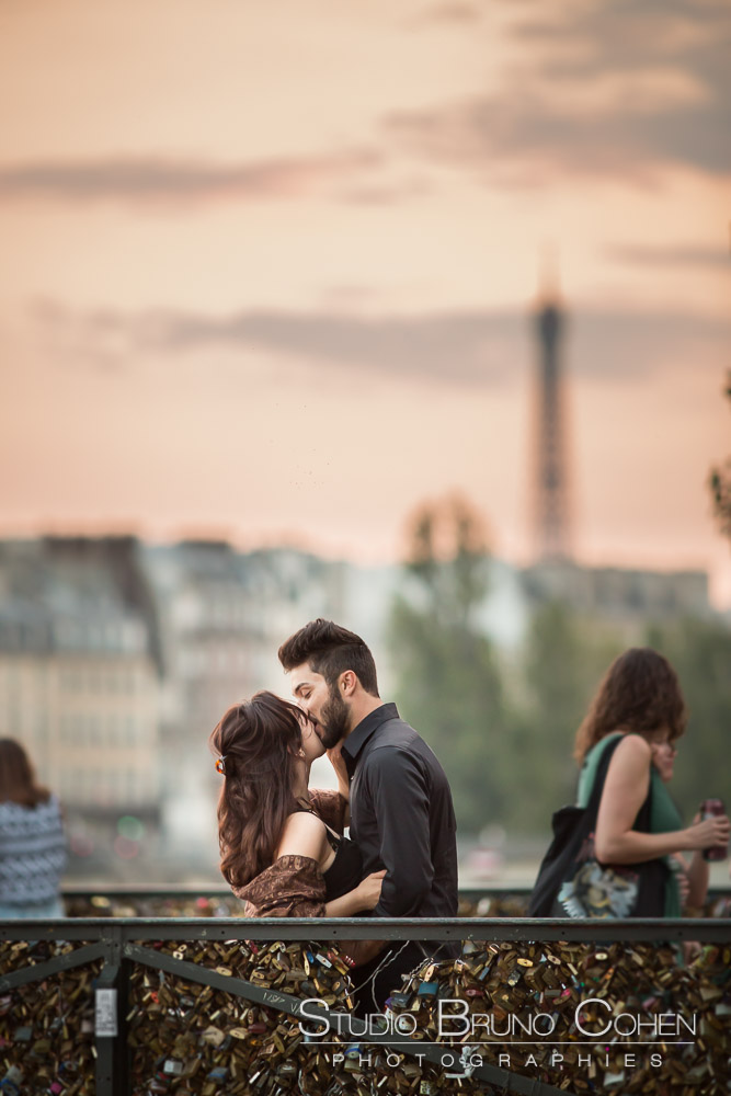 portrait kisisng couple on locks bridge from paris front of eiffel tower at sunset summer proposal 