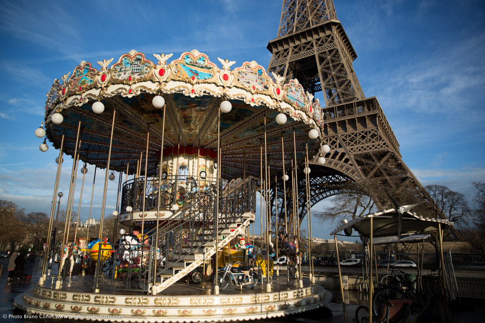 proposal in paris carousel front of Eiffel Tower blue sky