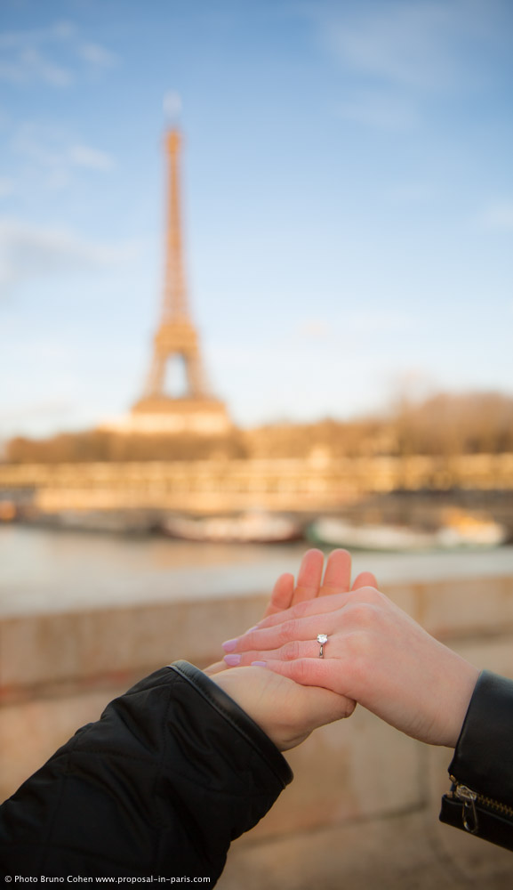 proposal in paris focus engagement ring front of Eiffel Tower at sunset
