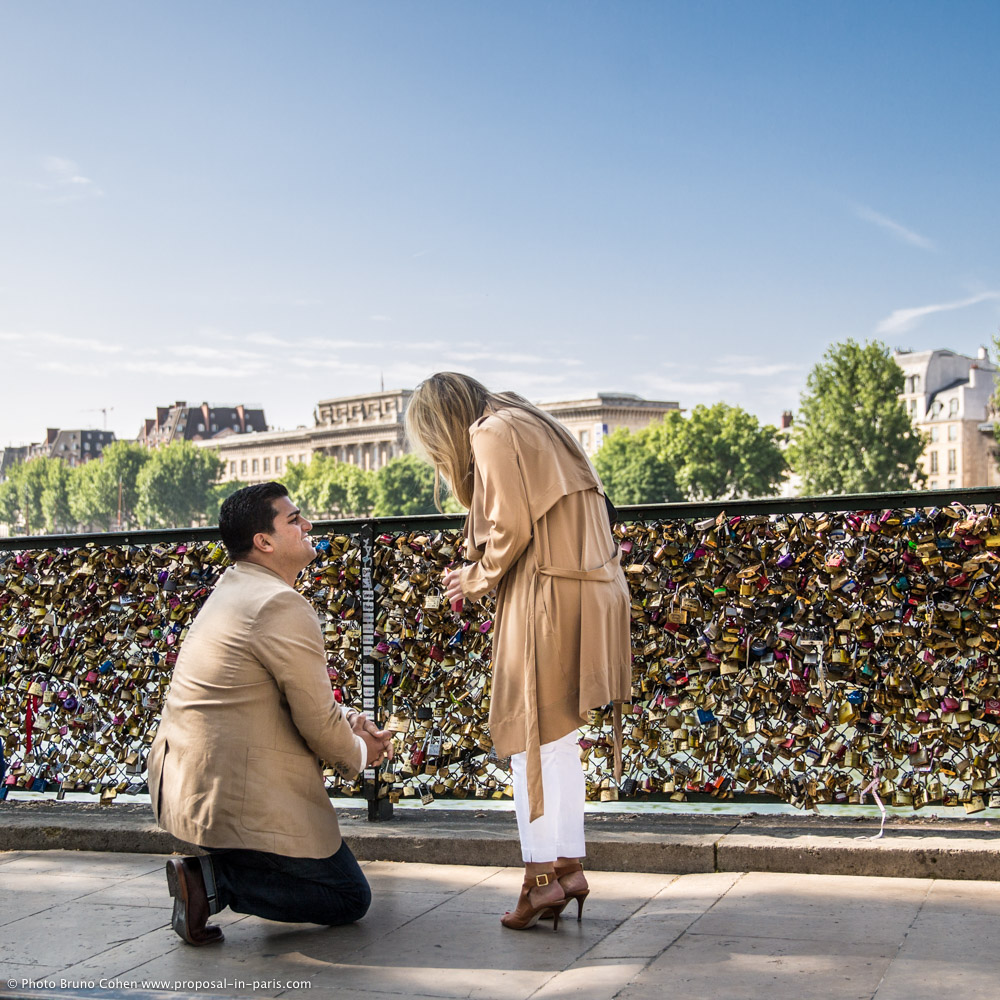 surprise proposal in paris from locks bridge couple in love