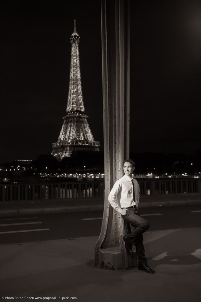 fashion portrait asian chic man from Bir Hakeim bridge front of Eiffel Tower in paris by night black and white