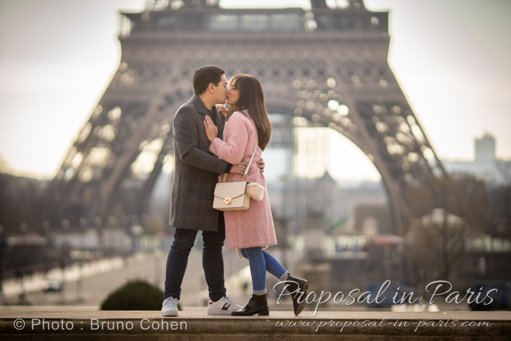 couple kissing with the Eiffel Tower bottom as a backdrop