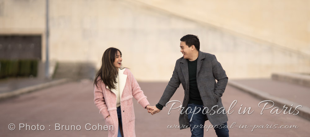 young couple laughing and holding hands