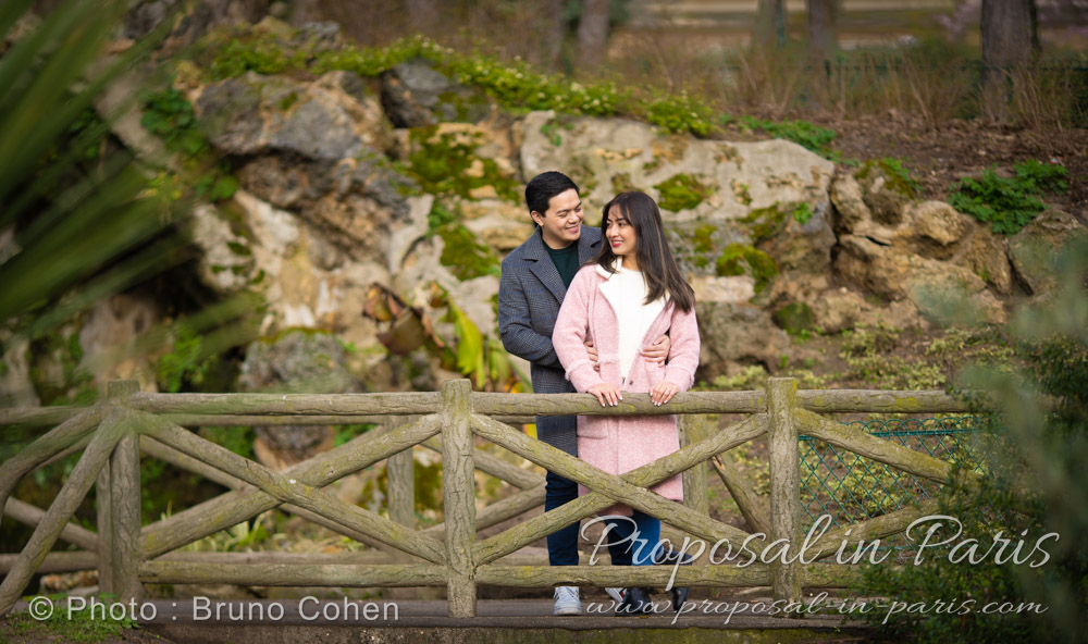couple standing on a bridge in Trocadero garden