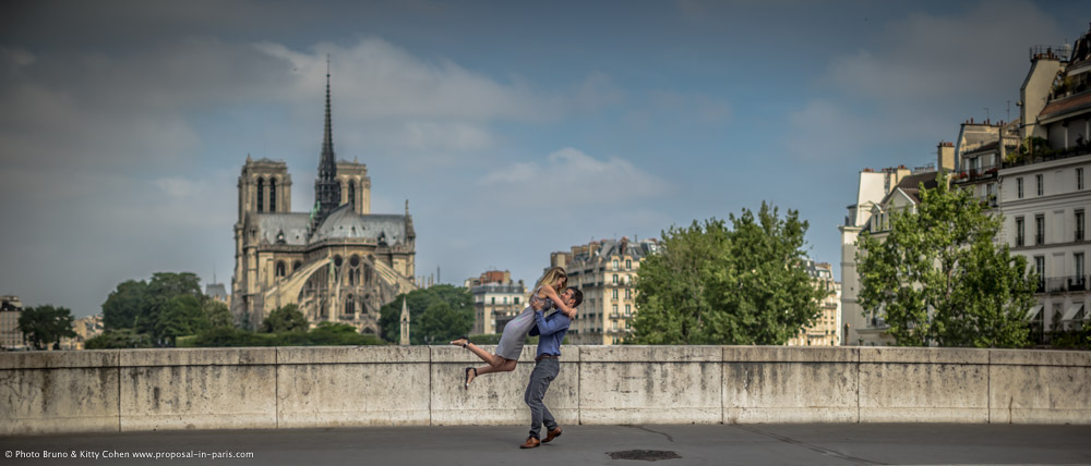 amazing portrait couple lady jumping in paris front of notre dame cathedral
