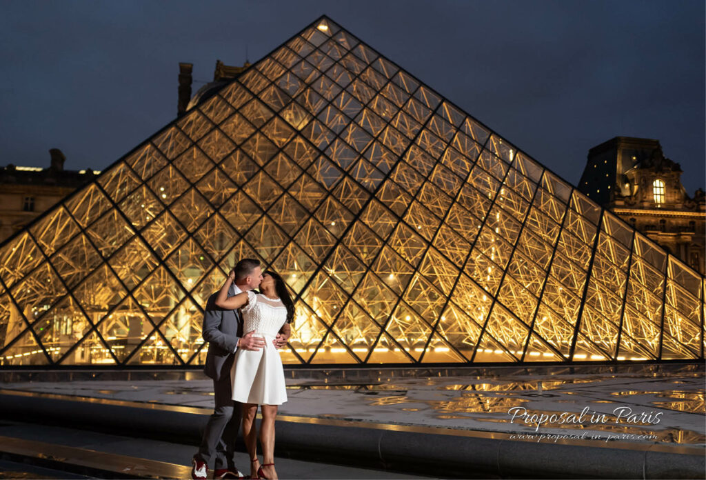 Couple shooting in front of the Louvre Museum Pyramid at night